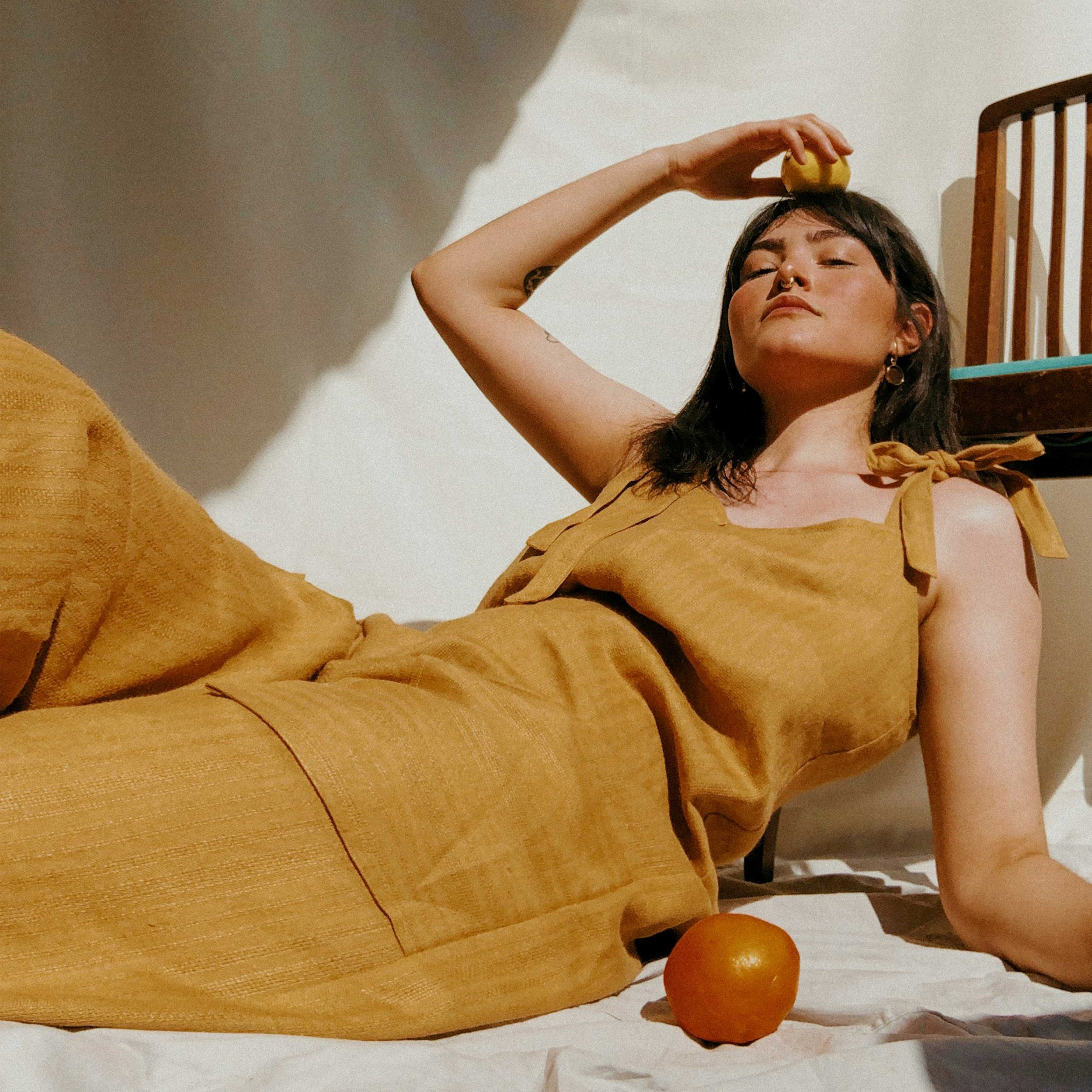 Fashion photography of a woman laying on a chair.